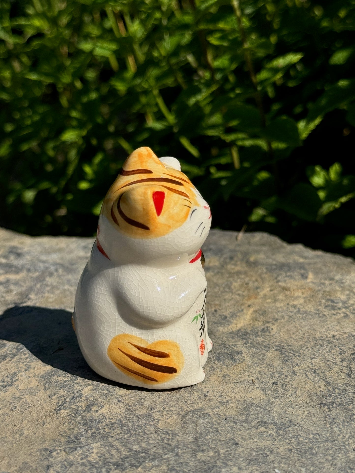 chat japonais Maneki Neko en céramique blanc et jaune, profil droit