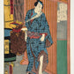 estampe japonaise homme en kimono bleu avec nécessaire à coiffure à la main