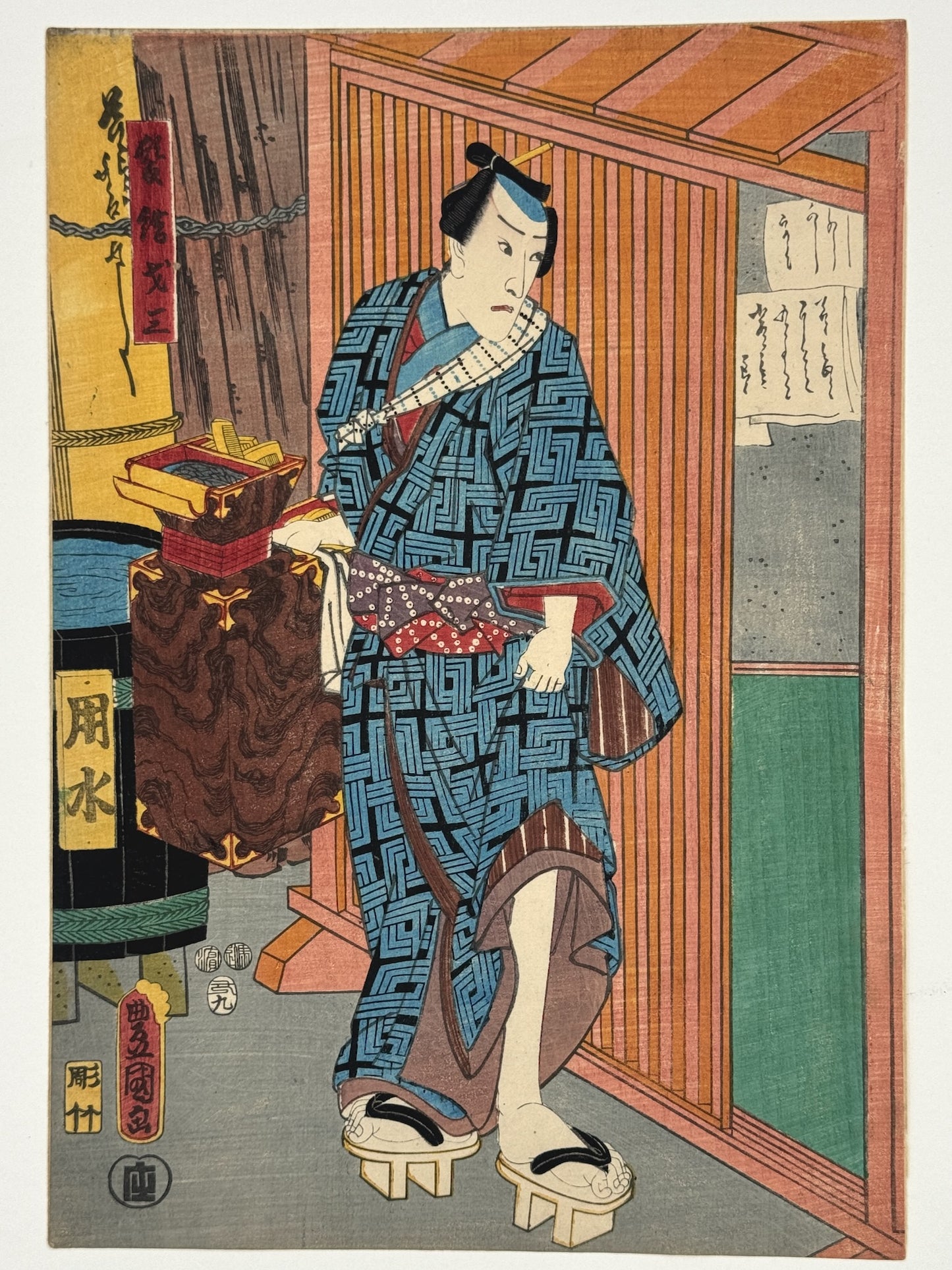 estampe japonaise homme en kimono bleu avec nécessaire à coiffure à la main